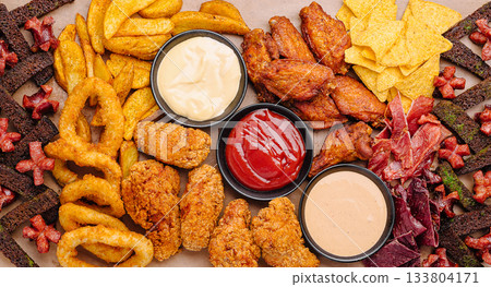 Delicious spread of assorted snacks and dips at a fun gathering Delicious spread of assorted snacks and dips at a fun gathering 133804171