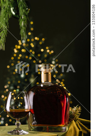 Warm holiday gathering with a glass of whiskey and festive decorations 133804186