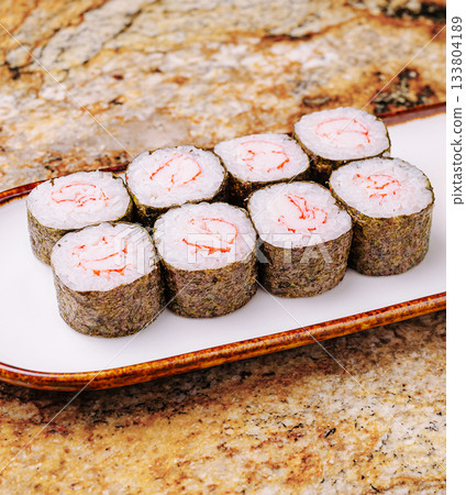 Sushi rolls with shrimp served on a plate in a beautiful restaurant setting Sushi rolls with shrimp served on a plate in a beautiful restaurant setting 133804189