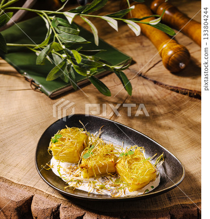 Delicious dish served on a wooden table with fresh herbs and spices Delicious dish served on a wooden table with fresh herbs and spices 133804244