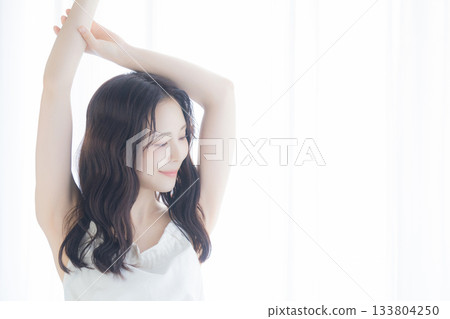 A woman basking in the morning sun A woman basking in the morning sun 133804250