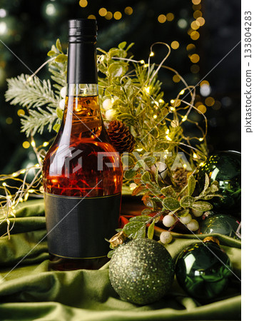 Elegant holiday drink setup with bottle and festive decorations 133804283