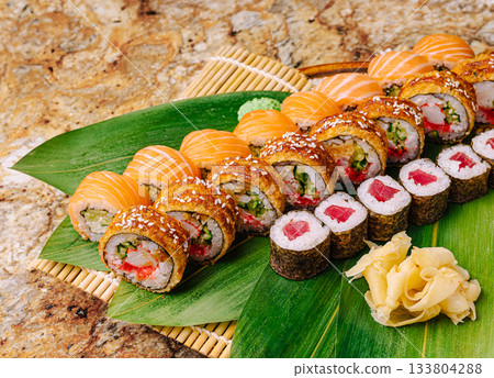 Sushi platter with a variety of rolls served on a bamboo mat 133804288