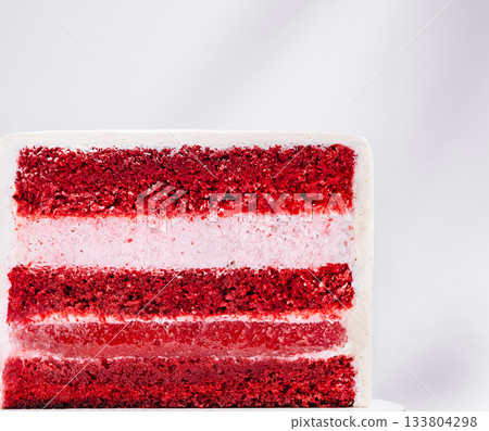 Moist red velvet cake with creamy layers served on a white background Moist red velvet cake with creamy layers served on a white background 133804298