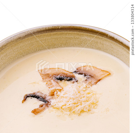 Delicious creamy mushroom soup served in a rustic bowl with garnishes 133804314