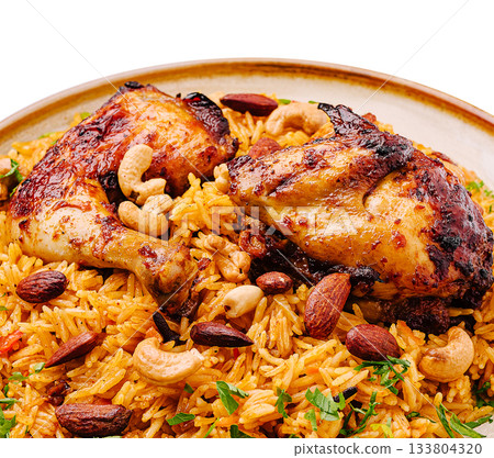 Delicious chicken and spiced rice dish with nuts and herbs served in a bowl Delicious chicken and spiced rice dish with nuts and herbs served in a bowl 133804320