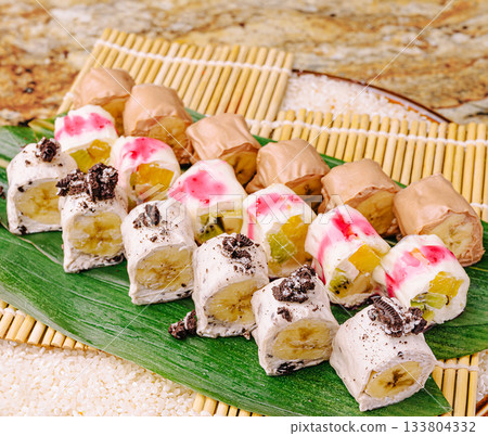 Colorful dessert platters with unique flavors served on a leaf Colorful dessert platters with unique flavors served on a leaf 133804332