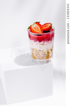 Delicious layered dessert with strawberries and cream on a white background Delicious layered dessert with strawberries and cream on a white background 133804341