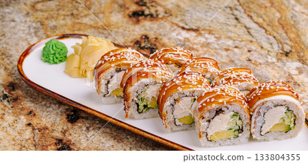 Delicious sushi rolls served on a plate with wasabi and ginger Delicious sushi rolls served on a plate with wasabi and ginger 133804355