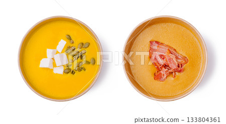 Delicious pumpkin soup served with toppings in wooden bowls 133804361