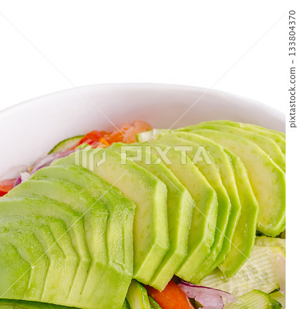 Freshly sliced avocado atop a colorful salad in a bowl Freshly sliced avocado atop a colorful salad in a bowl 133804370