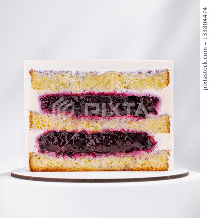 Delicious layered cake with berry filling displayed on a white background Delicious layered cake with berry filling displayed on a white background 133804474