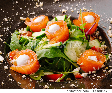 Delicious salmon salad with fresh greens and nuts served in a bowl Delicious salmon salad with fresh greens and nuts served in a bowl 133804478