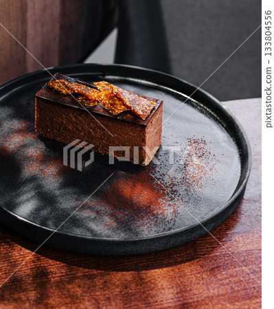 Delicious chocolate dessert served on a stylish plate in a modern caf? Delicious chocolate dessert served on a stylish plate in a modern caf? 133804556