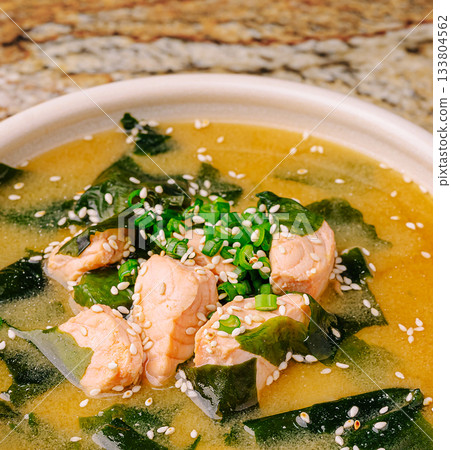 Delicious salmon soup with seaweed, sesame, and green onions in a bowl 133804562