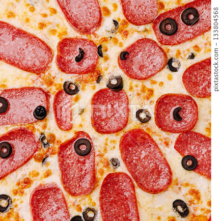 Delicious pepperoni pizza topped with black olives ready to be served Delicious pepperoni pizza topped with black olives ready to be served 133804568