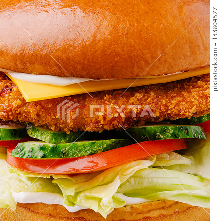 Crispy chicken sandwich with fresh vegetables on a soft bun Crispy chicken sandwich with fresh vegetables on a soft bun 133804577