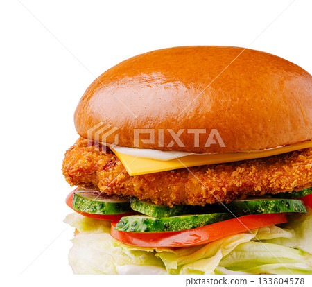 Crispy chicken sandwich with fresh vegetables and cheese on a bun Crispy chicken sandwich with fresh vegetables and cheese on a bun 133804578