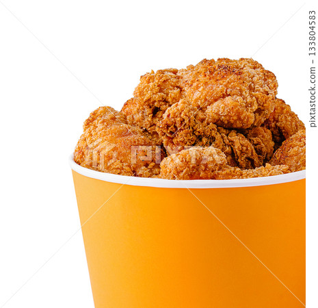 Crispy fried chicken served in a bright orange container 133804583