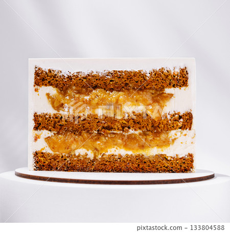 Unique layered dessert with cake and fruit filling on a plain backdrop Unique layered dessert with cake and fruit filling on a plain backdrop 133804588