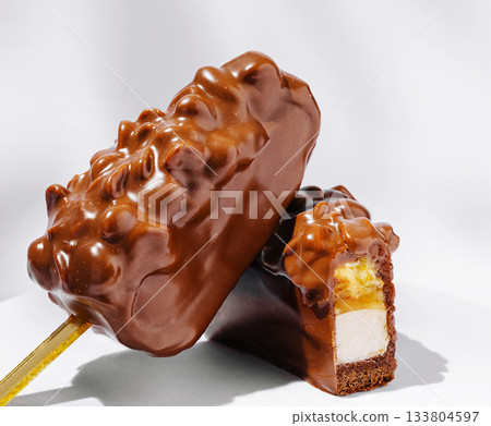 Chocolate coated ice cream bars with crunchy topping enjoyed on a cool day 133804597