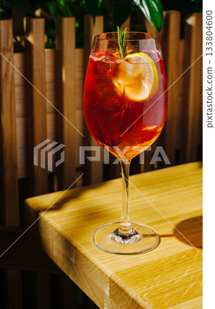 Refreshing beverage served in a tall glass on a wooden table 133804600