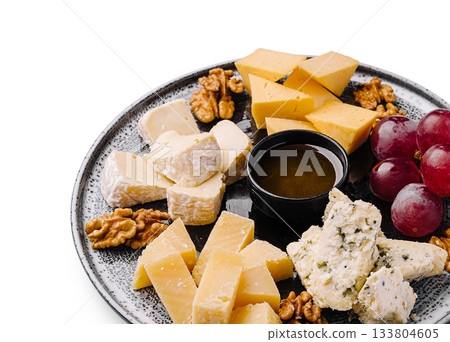 Delicious cheese platter with grapes, nuts, and honey for a perfect snack Delicious cheese platter with grapes, nuts, and honey for a perfect snack 133804605