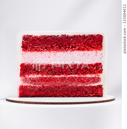 Red velvet cake with layers of cream cheese frosting on a white background 133804612
