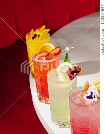 Colorful cocktails on a table in a vibrant bar during a lively evening Colorful cocktails on a table in a vibrant bar during a lively evening 133804647