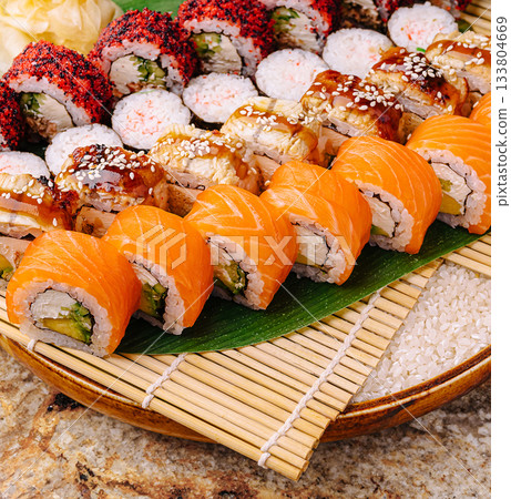 Sushi platter with colorful rolls and fresh ingredients at a festive gathering Sushi platter with colorful rolls and fresh ingredients at a festive gathering 133804669
