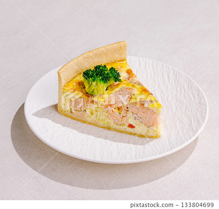 Delicious salmon quiche with fresh broccoli on a white plate 133804699