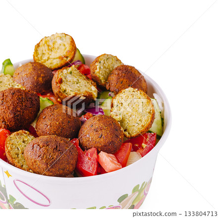 Enjoying fresh falafel salad with vegetables on a sunny day 133804713