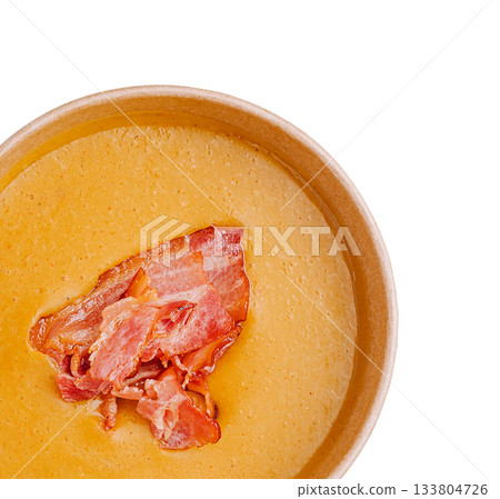Delicious corn soup topped with crispy bacon in a wooden bowl Delicious corn soup topped with crispy bacon in a wooden bowl 133804726