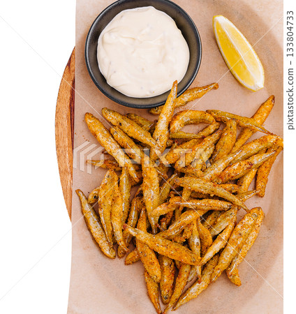 Deliciously crispy fried fish served with dipping sauce and lemon wedge 133804733