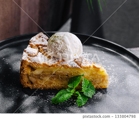 Delicious homemade apple pie served with vanilla ice cream on a plate 133804798