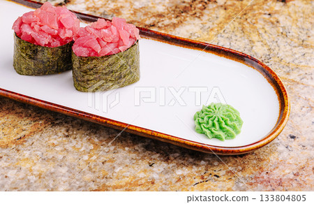 Fresh sushi rolls with tuna and wasabi on a decorative plate 133804805