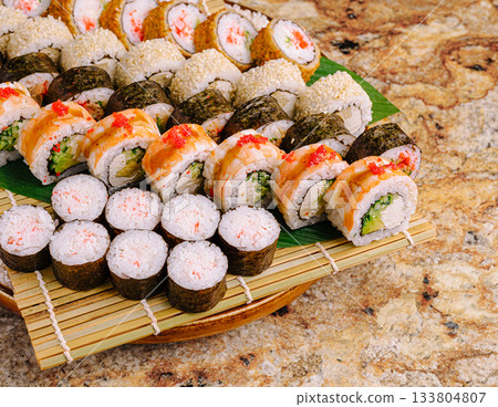Delicious sushi platter showcasing various types and styles of rolls Delicious sushi platter showcasing various types and styles of rolls 133804807