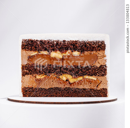 Delicious chocolate and caramel layered cake with banana filling 133804813
