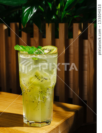 Refreshing kiwi mint drink served in a tall glass with ice Refreshing kiwi mint drink served in a tall glass with ice 133804818