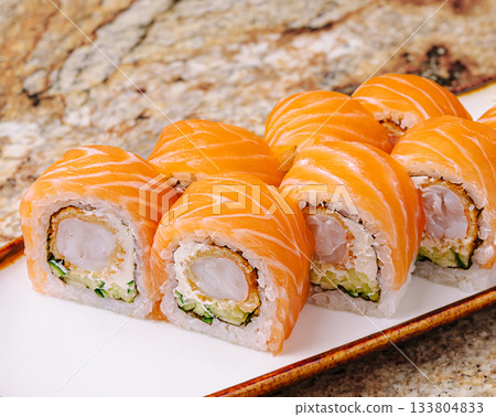 Fresh salmon sushi rolls served on a white plate at a sushi restaurant 133804833