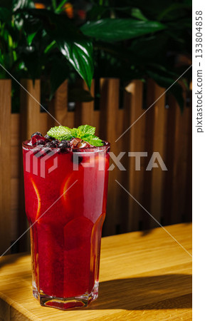 Refreshing berry drink served in a tall glass with mint garnish Refreshing berry drink served in a tall glass with mint garnish 133804858