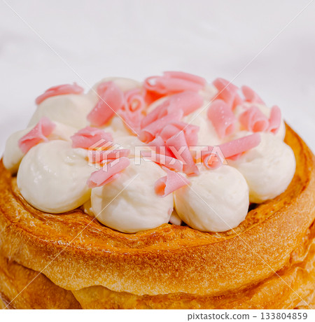 Delicious dessert topped with fluffy cream and pink sprinkles at sweet bakery 133804859