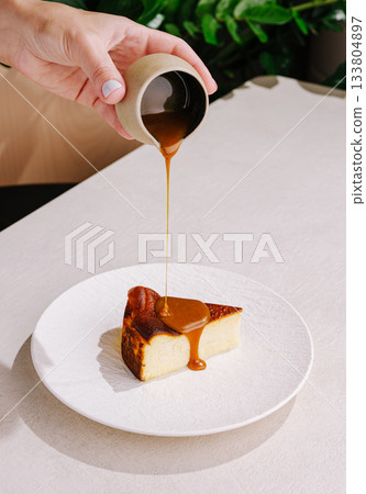 Delicious dessert being served with a rich caramel sauce 133804897