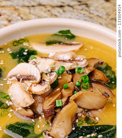Delicious warm soup with mushrooms and seaweed in a bowl Delicious warm soup with mushrooms and seaweed in a bowl 133804914