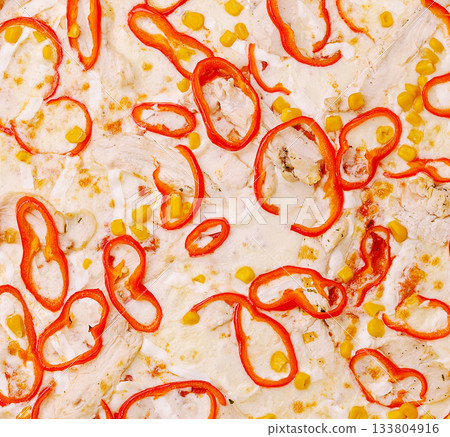 Colorful pizza topped with red peppers and corn on a white crust 133804916