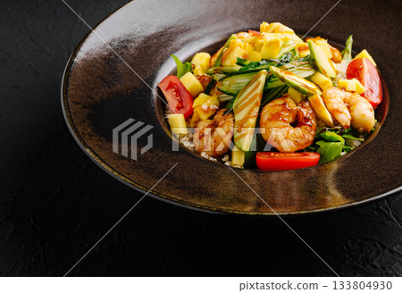 Shrimp salad with fresh vegetables, mango, and herbs served in a shallow bowl Shrimp salad with fresh vegetables, mango, and herbs served in a shallow bowl 133804930