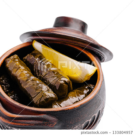 Delicious grape leaves stuffed with rice and herbs in traditional pot 133804957