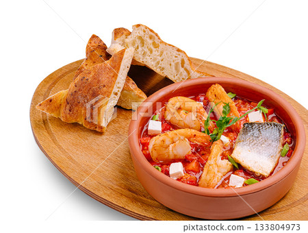 Delicious seafood stew served with crusty bread on a wooden board Delicious seafood stew served with crusty bread on a wooden board 133804973