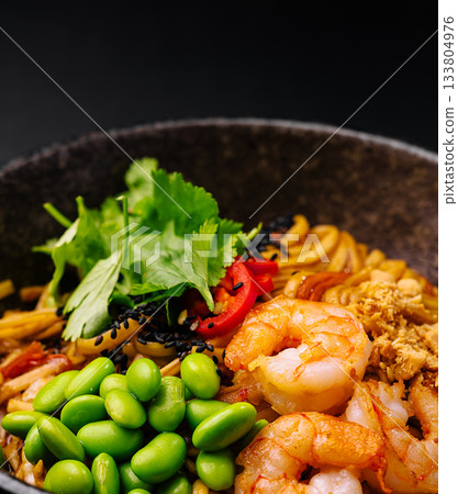 Delicious bowl of noodles with shrimp, edamame, and fresh herbs Delicious bowl of noodles with shrimp, edamame, and fresh herbs 133804976