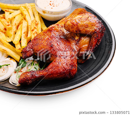 Delicious grilled chicken served with crispy fries and dipping sauce 133805071
